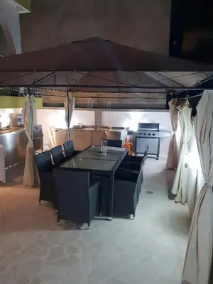 a living room with a table and chairs and a kitchen at Villa Medusa Apartments - Adults only - in Dobra Voda
