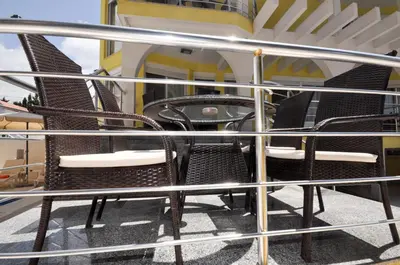 a group of chairs sitting on a balcony at Villa Medusa Apartments - Adults only - in Dobra Voda