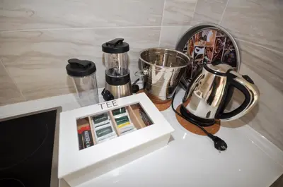 a white table with a coffee maker and appliances on it at Villa Medusa Apartments - Adults only - in Dobra Voda