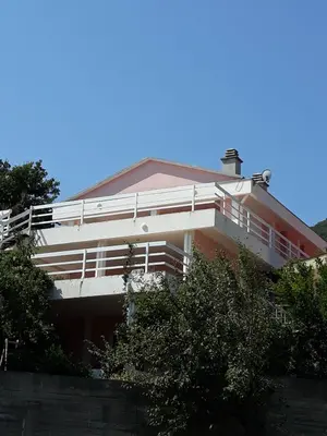 a building with a balcony on the side of it at Apartments Jovanic with 2 bedrooms in Sutomore