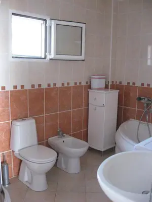 a bathroom with two toilets and a sink and a tub at Apartments Jovanic with 2 bedrooms in Sutomore