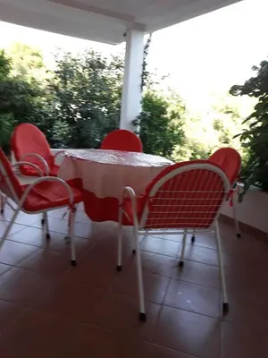 a table and chairs sitting on a porch at Apartments Jovanic with 2 bedrooms in Sutomore