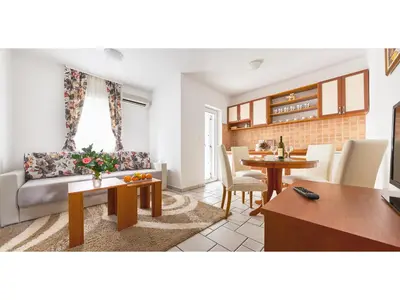 a living room with a couch and a table at Blue Mare Apartment in Petrovac na Moru