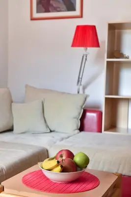 a bowl of fruit on a table next to a couch at Blue Mare Apartment in Petrovac na Moru