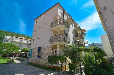 a building with balconies on the side of it at Blue Mare Apartment in Petrovac na Moru