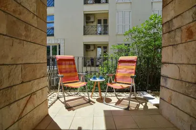 two chairs and a table on a balcony at Blue Mare Apartment in Petrovac na Moru