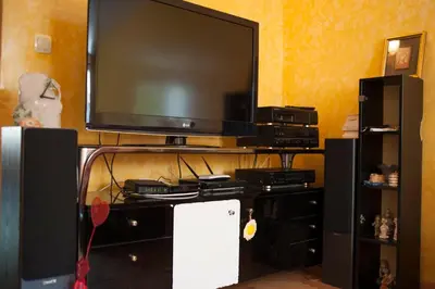 a flat screen tv sitting on top of a entertainment center at Apartment Mira in Budva