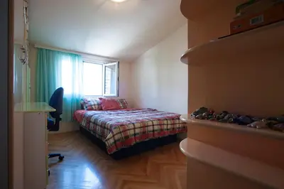 a small bedroom with a bed and a window at Apartment Mira in Budva