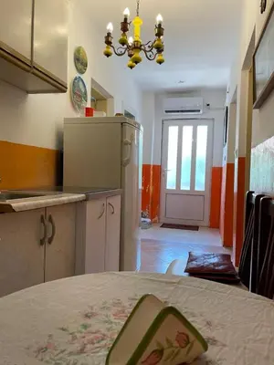 a kitchen with a table and a chandelier at Apartment Mira in Sutomore