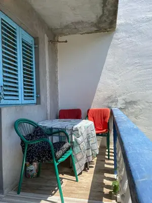 a table and two chairs sitting on a porch at Apartment Mira in Sutomore