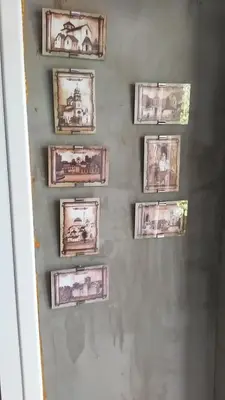 a wall with framed pictures on a wall at Apartment Mira in Sutomore