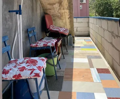 a group of chairs and tables on a patio at Apartment Mira in Sutomore