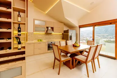 a kitchen and dining room with a table and chairs at Kotor Luxury View in Kotor