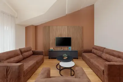 a living room with two brown couches and a tv at Kotor Luxury View in Kotor