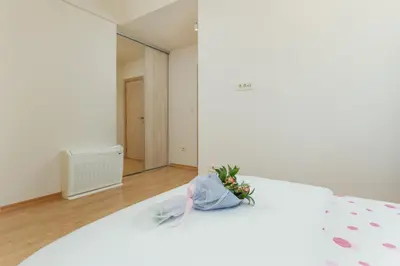 a white bed with a bouquet of flowers on it at Kotor Luxury View in Kotor