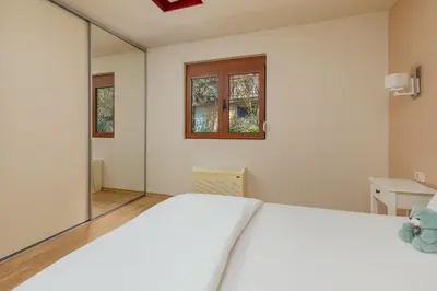a bedroom with a white bed and a large mirror at Kotor Luxury View in Kotor