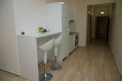 a kitchen with a counter and two stools in it at Nautilus Apartments in Dobra Voda