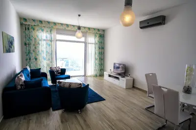 a living room with a couch and chairs and a television at Nautilus Apartments in Dobra Voda