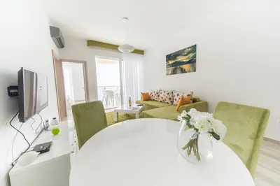 a living room with a white table and chairs at Nautilus Apartments in Dobra Voda