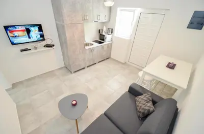 an overhead view of a living room with a couch and a tv at Bay View Apartments in Kotor