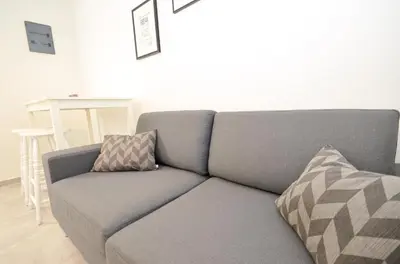 a gray couch with two pillows on it in a living room at Bay View Apartments in Kotor