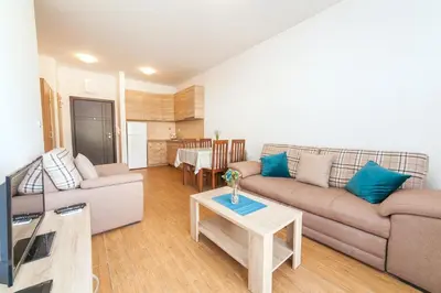 a living room with a couch and a table at Welcome Apartments in Petrovac na Moru