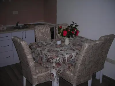 a table and chairs with a table and flowers on it at Apartment Dragan in Budva