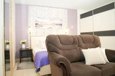 a living room with a couch and a bed at Apartments Bućin in Kotor