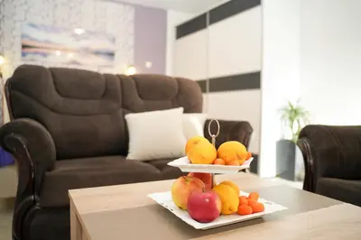 a table with two plates of fruit on top of it at Apartments Bućin in Kotor