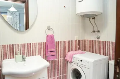 a bathroom with a washing machine and a sink at Apartments Bućin in Kotor