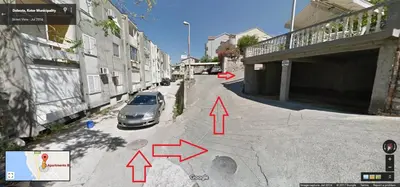 a car parked on a street next to a building at Apartments Blue Sea in Kotor
