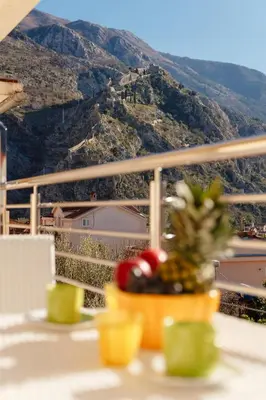 a bowl of fruit on a table with a view at Apartments Blue Sea in Kotor