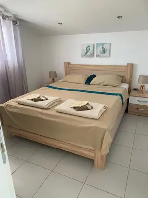 a bedroom with a large bed with towels on it at Apartments Ljiljana in Bar