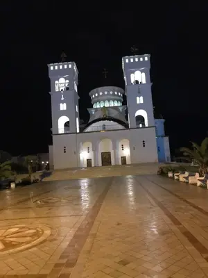 a large building with two towers at night at Apartments Ljiljana in Bar