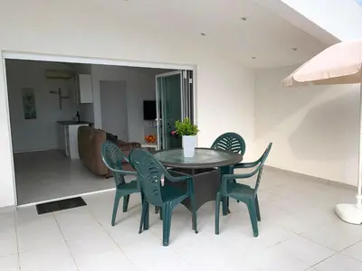 a table and chairs in a living room at Apartments Ljiljana in Bar