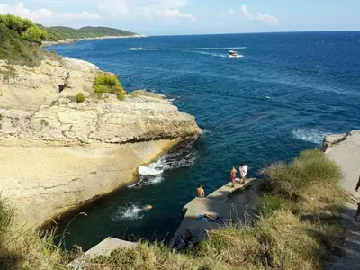 two people standing on the edge of a body of water at House Kraja in Ulcinj