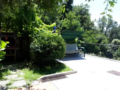 a park bench sitting next to a bush at Apartment Sofia in Sutomore