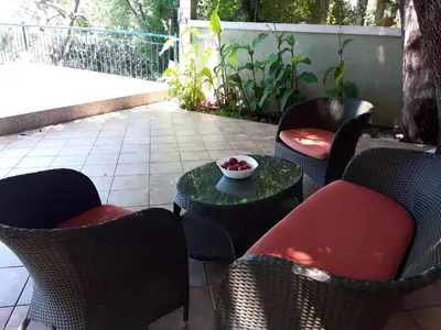 a patio with chairs and a bowl of fruit on a table at Apartment Sofia in Sutomore