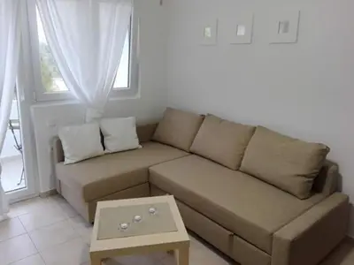 a living room with a couch and a coffee table at Apartmani Vukmanovic in Čanj