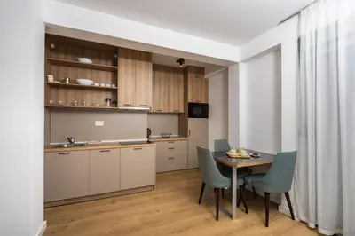 a kitchen and dining room with a table and chairs at Apartments My Przno in Sveti Stefan
