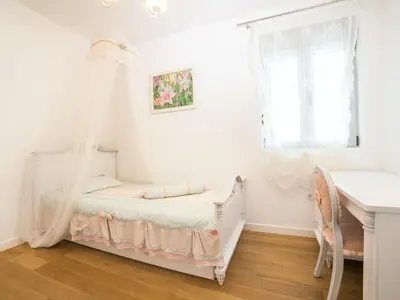 a bedroom with a bed with a mosquito net at Apartments My Przno in Sveti Stefan