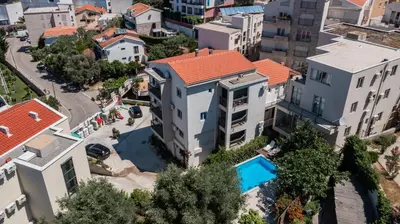 an aerial view of a building with a swimming pool at Apartments My Przno in Sveti Stefan