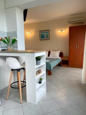 a living room with a desk and a bedroom at Apartments SoleMar2 in Sutomore