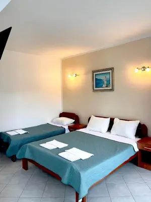 a room with two beds in a room at Apartments SoleMar2 in Sutomore