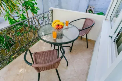 a glass table with bananas on it on a balcony at Apartments SoleMar2 in Sutomore