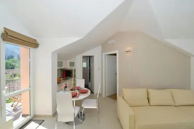 a living room with a couch and a table at Sunshine of Montenegro - Family Oasis in Kotor