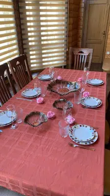 a table with plates and glasses on a red table cloth at Villa Coast of Montenegro in Bar
