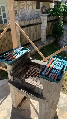 a grill in a yard next to a house at Villa Coast of Montenegro in Bar