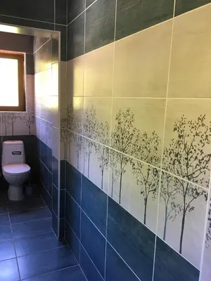 a bathroom with blue tile with trees on the wall at Villa Coast of Montenegro in Bar