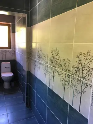 a bathroom with a blue tiled wall with trees painted on it at Villa Coast of Montenegro in Bar